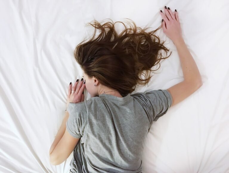 A peaceful bedroom scene with a soft pillow and a hair care product on the bedside table, emphasizing nighttime hair care.