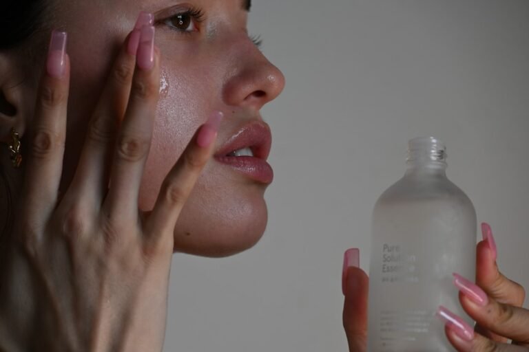 A serene bathroom counter with skincare products arranged neatly, including cleansers, moisturizers, and serums, with soft natural light illuminating the scene.