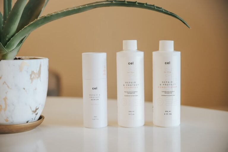 A serene bathroom setting with hair care products neatly arranged, showcasing shampoo, conditioner, and a hairbrush on a wooden countertop.
