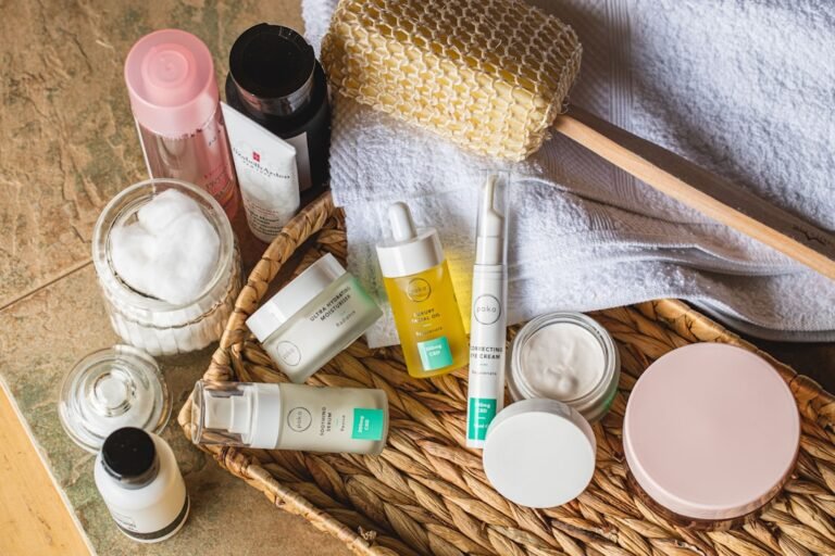 A close-up of a woman applying moisturizer to her face in a bright, airy bathroom setting, showcasing a healthy skincare routine.