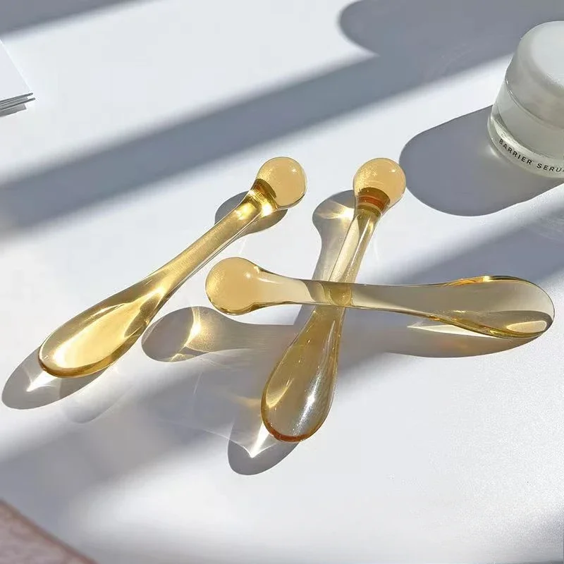 Transparent plastic eye cream applicator spoon and roller, 3-pack on a white background – view 4