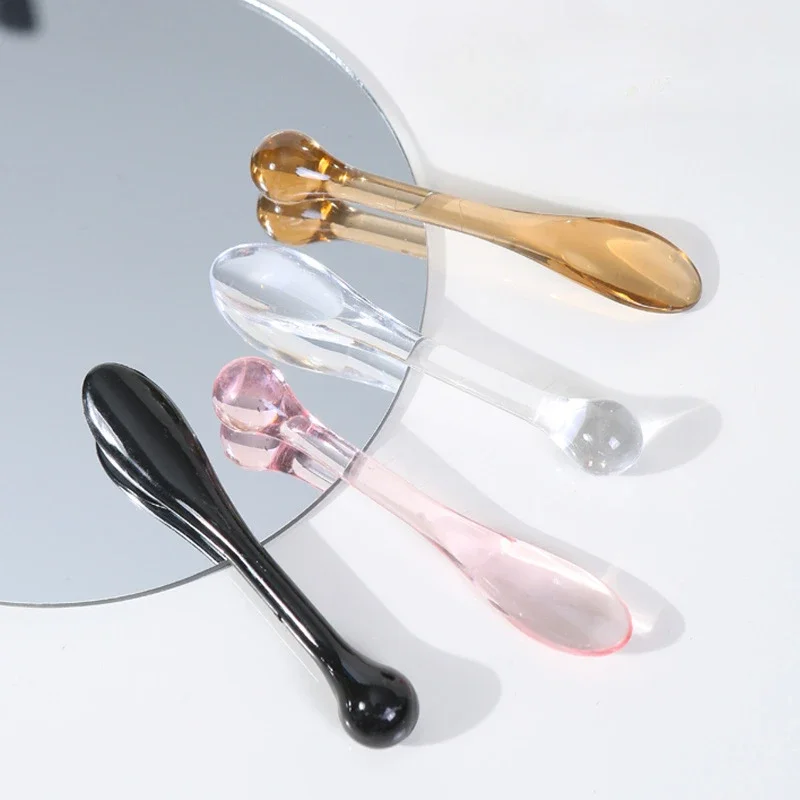 Transparent plastic eye cream applicator spoon and roller, 3-pack on a white background – view 2